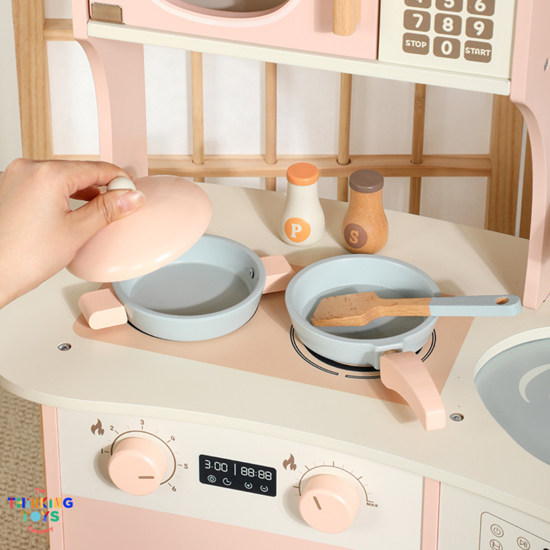 KP011, PLAYSHOP Cassey Corner Kitchen with Laundry, The Playshop Corner Kitchen with Laundry is a 2-in-1 pretend play set designed for little homemakers. With a compact corner design, it features a cooking station and a mini laundry area, encouraging kids to explore both cooking and cleaning through play. This wooden playset promotes creativity, role play, and independence, helping children understand everyday routines while having fun. Perfect for small spaces, it blends durability and child-safe design fo
